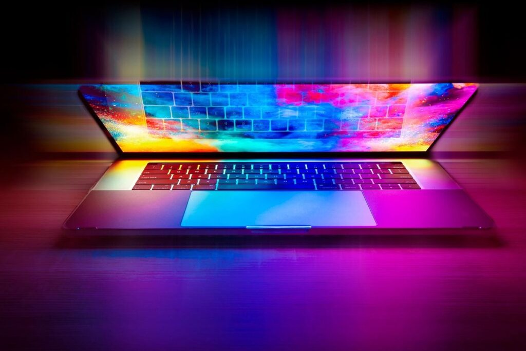 Un ordinateur portable ouvert sur une surface, écran coloré et clavier visibles